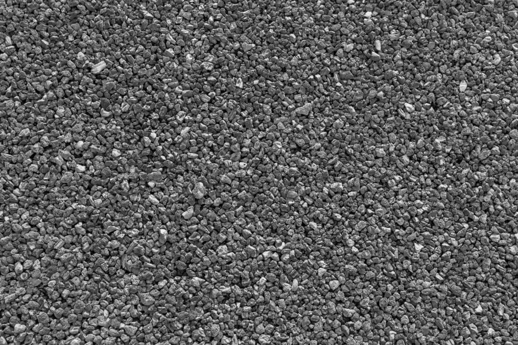 Texture de gravier noir et blanc aux petits cailloux concassés répartis de manière uniforme.